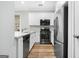 Modern kitchen featuring stainless steel appliances, white cabinets, and sleek countertops at 1283 Mercer, East Point, GA 30344