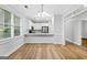 Open dining area with a view of the pristine kitchen with white cabinets and stainless steel appliances at 1283 Mercer, East Point, GA 30344