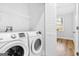 Laundry room features a white washer, dryer and wire shelving at 1283 Mercer, East Point, GA 30344