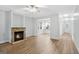 Spacious living room featuring a stone fireplace, wood floors, and an open view to the kitchen at 1283 Mercer, East Point, GA 30344