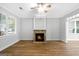 Bright living room with hardwood floors, a stone fireplace, and neutral color scheme with lots of natural light at 1283 Mercer, East Point, GA 30344