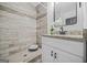 Modern bathroom with tiled shower, granite countertop, and white vanity at 1092 Donnelly Sw Ave, Atlanta, GA 30310