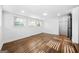 Bedroom with hardwood floors, natural light, and a black paneled door at 1092 Donnelly Sw Ave, Atlanta, GA 30310