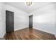 Bedroom with hardwood floors and neutral walls featuring two doors at 1092 Donnelly Sw Ave, Atlanta, GA 30310