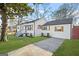 This home has a long driveway, freshly painted white exterior, and dark shutters and roof at 1092 Donnelly Sw Ave, Atlanta, GA 30310