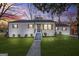 Charming single-story home with new exterior paint, dark roof and shutters, and a manicured lawn at 1092 Donnelly Sw Ave, Atlanta, GA 30310