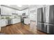 Modern kitchen with white cabinets, granite counters, stainless steel appliances, and hardwood floors at 1092 Donnelly Sw Ave, Atlanta, GA 30310