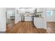 Open concept kitchen with white cabinets, stainless steel appliances, and hardwood floors at 1092 Donnelly Sw Ave, Atlanta, GA 30310