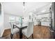 Open concept kitchen and dining room with white cabinets, stainless steel appliances, and modern dining set at 1092 Donnelly Sw Ave, Atlanta, GA 30310