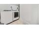 Bright laundry room with new washer and dryer on travertine tile flooring at 1092 Donnelly Sw Ave, Atlanta, GA 30310