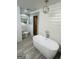 Bathroom features a soaking tub, wood accent door, and a stylish hanging light fixture at 2410 Thrasher Rd, Buford, GA 30519