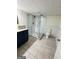 Modern bathroom featuring a glass enclosed shower with gray tiling and a blue vanity with a marble countertop at 2410 Thrasher Rd, Buford, GA 30519