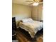 Bedroom with wood floors, ceiling fan, and a large window at 2410 Thrasher Rd, Buford, GA 30519