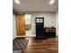 Inviting entryway with wood floors, hall tree, and barn door leading to a bathroom at 2410 Thrasher Rd, Buford, GA 30519