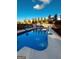 Sparkling in-ground pool with a basketball hoop, surrounded by a concrete deck, and a well-maintained backyard at 2410 Thrasher Rd, Buford, GA 30519