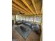 This screened-in back porch features comfortable seating on a wood floor and exposed wood ceiling at 25 Castlehill Ct, Covington, GA 30016