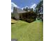 This backyard features a screened-in back porch and artificial turf at 25 Castlehill Ct, Covington, GA 30016