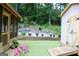 The backyard features green turf, a storage shed and a raised garden bed at 25 Castlehill Ct, Covington, GA 30016