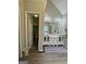 Bright bathroom with dual sinks, white cabinetry, and access to separate toilet at 25 Castlehill Ct, Covington, GA 30016