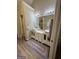Modern bathroom featuring a double vanity, marble countertops, and contemporary lighting at 25 Castlehill Ct, Covington, GA 30016
