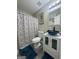 This bathroom features a blue glass vessel sink and a patterned shower curtain at 25 Castlehill Ct, Covington, GA 30016