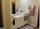 Stylish bathroom with double vessel sinks, marble countertops, and white cabinetry at 25 Castlehill Ct, Covington, GA 30016