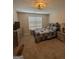 Bedroom featuring neutral carpet, light fixture, and a large window at 25 Castlehill Ct, Covington, GA 30016