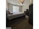 A cozy bedroom with ceiling fan features ample space and a large window at 25 Castlehill Ct, Covington, GA 30016