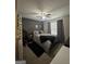 This charming bedroom features a ceiling fan, patterned bedding, curtains, and stylish decor at 25 Castlehill Ct, Covington, GA 30016