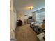 Bedroom featuring neutral carpet, light fixture, a desk, and a large window at 25 Castlehill Ct, Covington, GA 30016