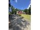 Charming brick home with a long driveway and lush green lawn under a clear blue sky at 25 Castlehill Ct, Covington, GA 30016