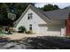 Exterior view of the house with a garage, basketball hoop, and well-kept landscaping at 25 Castlehill Ct, Covington, GA 30016