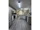 A spacious kitchen features granite countertops, stainless appliances and modern gray flooring at 25 Castlehill Ct, Covington, GA 30016