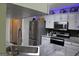 Contemporary kitchen with granite countertops, stainless steel appliances, and modern lighting at 25 Castlehill Ct, Covington, GA 30016