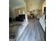 Open-concept living and dining areas with sleek flooring, fireplace, and modern furnishings at 25 Castlehill Ct, Covington, GA 30016