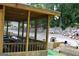 Relaxing screened porch with outdoor furniture and views of the landscaped backyard at 25 Castlehill Ct, Covington, GA 30016