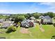 Aerial view of the home, large lawn, and surrounding neighborhood at 411 Hickory Fairway Ct, Woodstock, GA 30188