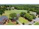 Beautiful red brick home with a well-manicured lawn and mature trees, located on a golf course at 411 Hickory Fairway Ct, Woodstock, GA 30188