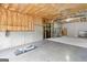 Unfinished basement space showing exposed beams and concrete flooring at 411 Hickory Fairway Ct, Woodstock, GA 30188