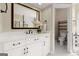 Stylish bathroom featuring a white vanity with a large mirror and sleek fixtures at 411 Hickory Fairway Ct, Woodstock, GA 30188