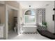 Bright bathroom with a soaking tub, walk-in shower, and unique tile accents at 411 Hickory Fairway Ct, Woodstock, GA 30188