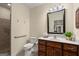 Bathroom featuring a walk-in shower, white toilet, vanity, and decorative elements at 411 Hickory Fairway Ct, Woodstock, GA 30188