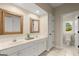 Bathroom features a double sink vanity with granite countertops at 411 Hickory Fairway Ct, Woodstock, GA 30188