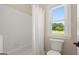 Bright bathroom with a tub and a view from the window, offering a refreshing space at 411 Hickory Fairway Ct, Woodstock, GA 30188