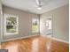 Spacious bedroom with hardwood floors, large windows, and neutral walls that provide a bright and airy feel at 411 Hickory Fairway Ct, Woodstock, GA 30188