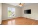 Bright bedroom featuring wood flooring and large windows providing ample natural light at 411 Hickory Fairway Ct, Woodstock, GA 30188