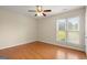 Bedroom with light walls, wood floors, a ceiling fan, and large windows at 411 Hickory Fairway Ct, Woodstock, GA 30188