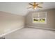 Cozy carpeted bedroom with ample natural light from window, complete with a ceiling fan at 411 Hickory Fairway Ct, Woodstock, GA 30188