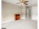 Neutral carpeted bedroom is bright with a lighted ceiling fan and convenient closet and shelving at 411 Hickory Fairway Ct, Woodstock, GA 30188