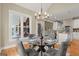 Cozy dining area adjacent to kitchen with glass-topped table and seating for four at 411 Hickory Fairway Ct, Woodstock, GA 30188
